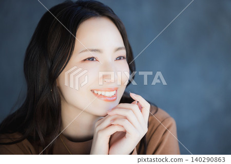 A woman smiling with a cheek A woman smiling with a cheek 140290863