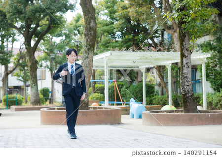 Businessman walking outdoors Businessman walking outdoors 140291154