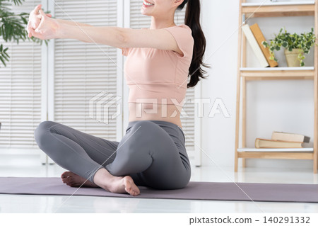 Women exercising and stretching at home Women exercising and stretching at home 140291332