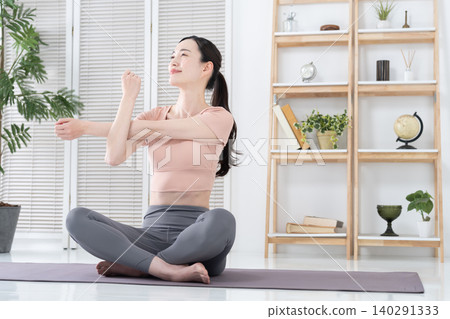 Women exercising and stretching at home Women exercising and stretching at home 140291333