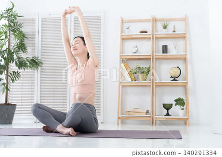Women exercising and stretching at home Women exercising and stretching at home 140291334