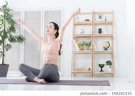 Women exercising and stretching at home Women exercising and stretching at home 140291335