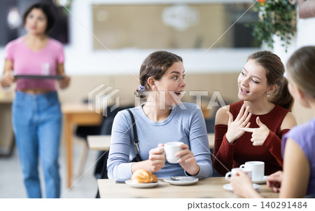 Three girls are chatting sweetly during tea party Three girls are chatting sweetly during tea party 140291484