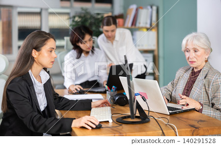 Female colleagues of different ages working in modern office 140291528