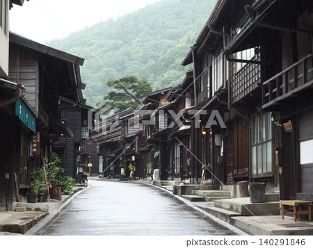 The cobblestone streets and old townscape of Narai-juku, wet with rain. The cobblestone streets and old townscape of Narai-juku, wet with rain. 140291846