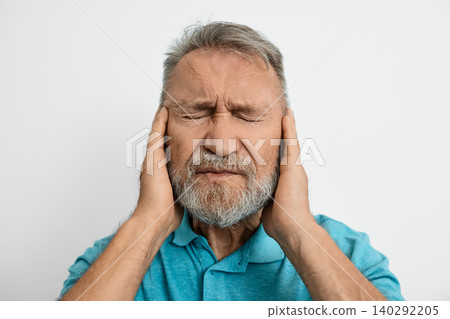 Elderly man feels discomfort in his ear, illustrating the challenges of hearing loss and ear problems he faces daily Elderly man feels discomfort in his ear, illustrating the challenges of hearing loss and ear problems he faces daily 140292205