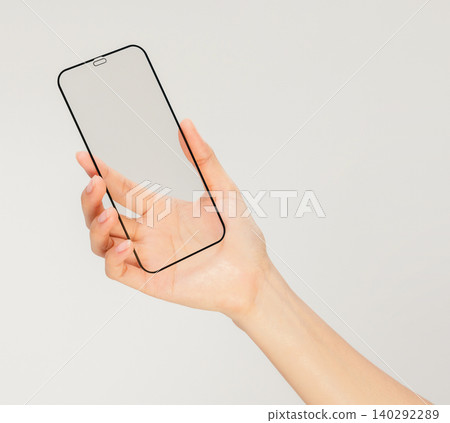 Clipping path, Gesture of hand holding smartphone with a blank screen, for mobile app mockup and digital technology concept. Clipping path, Gesture of hand holding smartphone with a blank screen, for mobile app mockup and digital technology concept. 140292289