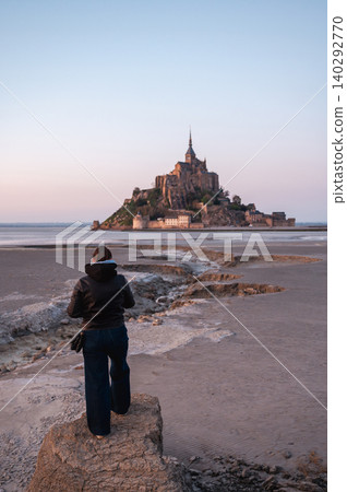 Girl Standing in Front of Mont-Saint-Michel, France Girl Standing in Front of Mont-Saint-Michel, France 140292770