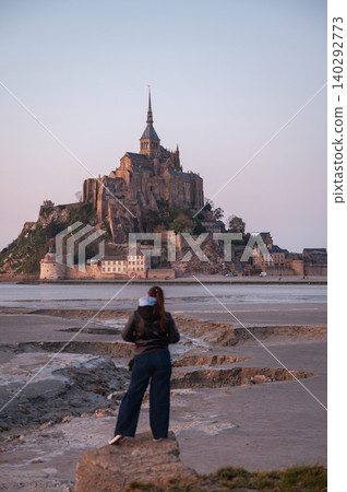 Girl Standing in Front of Mont-Saint-Michel, France Girl Standing in Front of Mont-Saint-Michel, France 140292773