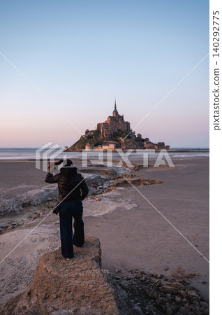 Girl Standing in Front of Mont-Saint-Michel, France Girl Standing in Front of Mont-Saint-Michel, France 140292775