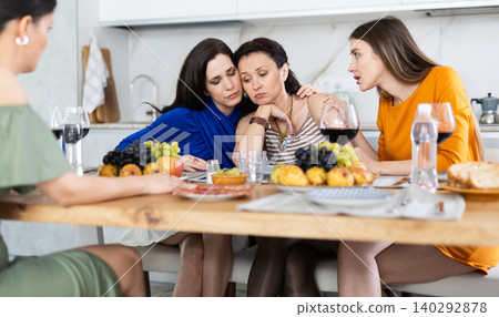 Female friends consoling upset bestie during friendly get-together Female friends consoling upset bestie during friendly get-together 140292878