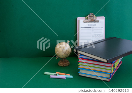Colorful school supplies on a green background Colorful school supplies on a green background 140292913