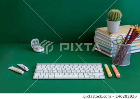 Colorful school supplies on a green background Colorful school supplies on a green background 140292920