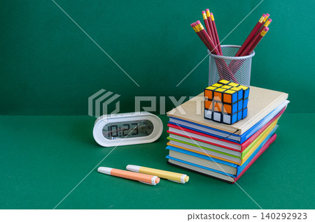 Colorful school supplies on a green background Colorful school supplies on a green background 140292923