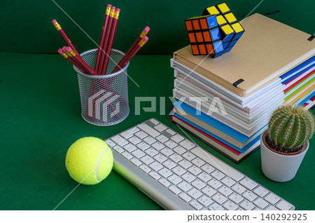 Colorful school supplies on a green background Colorful school supplies on a green background 140292925