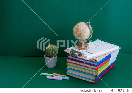 Colorful school supplies on a green background Colorful school supplies on a green background 140292926