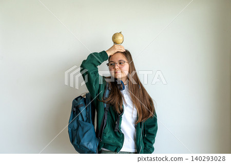 Teenage student holding a globe on white background Teenage student holding a globe on white background 140293028