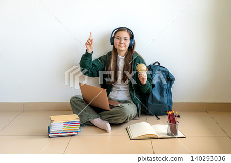 Teenage student holding a laptop on white background 140293036