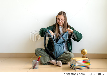 Teenage student holding books on white background Teenage student holding books on white background 140293037