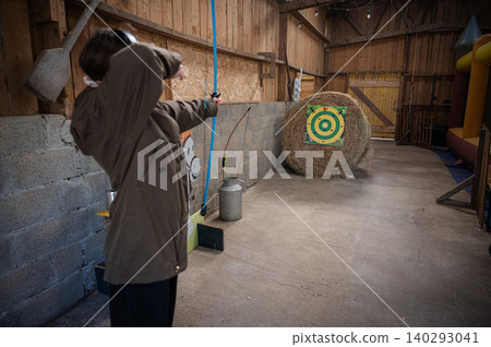 Girl Practicing with Bow and Arrows 140293041