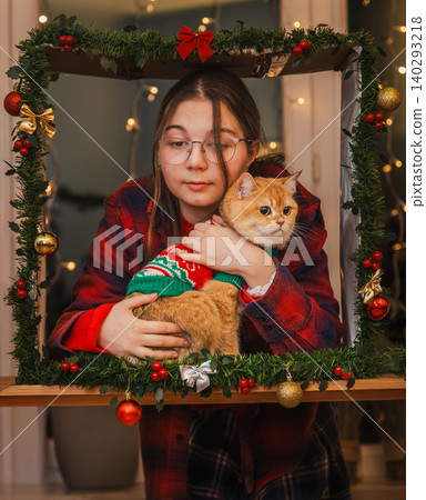 Smiling Teen Girl Holding Cat in Festive Frame Smiling Teen Girl Holding Cat in Festive Frame 140293218