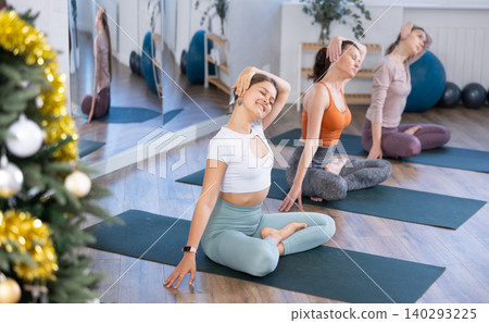 Group of women doing stretching in studio Group of women doing stretching in studio 140293225