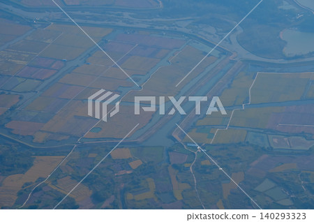 The view of China city from the airplane window. Aerial view of cityscape, the land of China, Asia. Travel and landscape scene. Travel and nature concept.  140293323