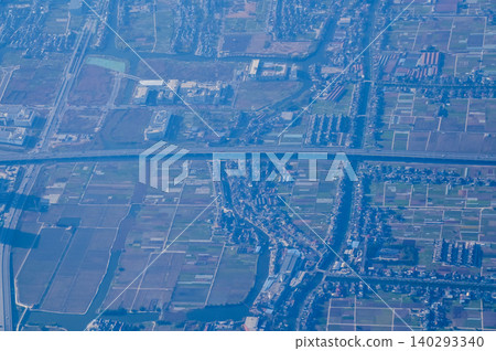 The view of China city from the airplane window. Aerial view of cityscape, the land of China, Asia. Travel and landscape scene. Travel and nature concept. The view of China city from the airplane window. Aerial view of cityscape, the land of China, Asia. Travel and landscape scene. Travel and nature concept. 140293340