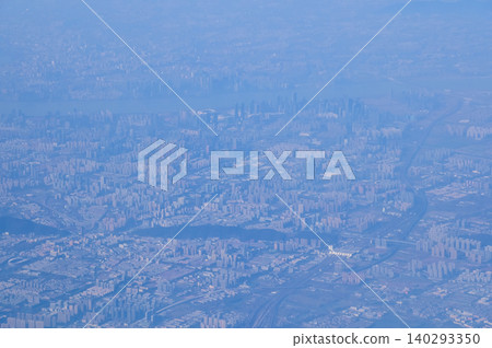 The view of China city from the airplane window. Aerial view of cityscape, the land of China, Asia. Travel and landscape scene. Travel and nature concept. The view of China city from the airplane window. Aerial view of cityscape, the land of China, Asia. Travel and landscape scene. Travel and nature concept. 140293350