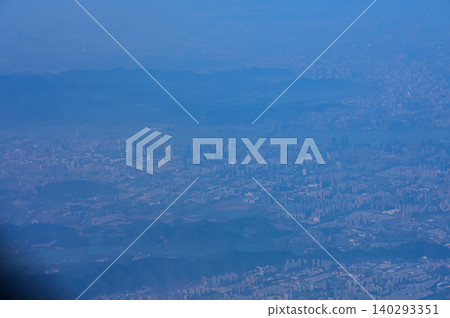 The view of China city from the airplane window. Aerial view of cityscape, the land of China, Asia. Travel and landscape scene. Travel and nature concept. The view of China city from the airplane window. Aerial view of cityscape, the land of China, Asia. Travel and landscape scene. Travel and nature concept. 140293351