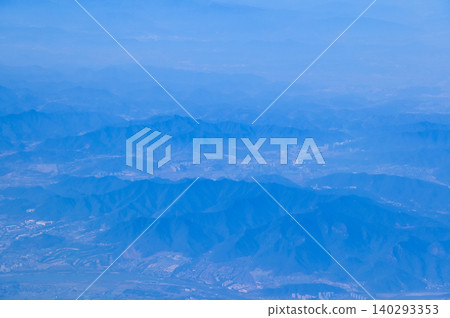 The view of China city from the airplane window. Aerial view of cityscape, the land of China, Asia. Travel and landscape scene. Travel and nature concept. The view of China city from the airplane window. Aerial view of cityscape, the land of China, Asia. Travel and landscape scene. Travel and nature concept. 140293353