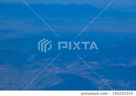 The view of China city from the airplane window. Aerial view of cityscape, the land of China, Asia. Travel and landscape scene. Travel and nature concept.  140293354