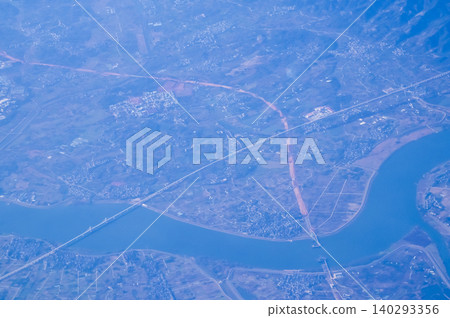 The view of China city from the airplane window. Aerial view of cityscape, the land of China, Asia. Travel and landscape scene. Travel and nature concept.  140293356