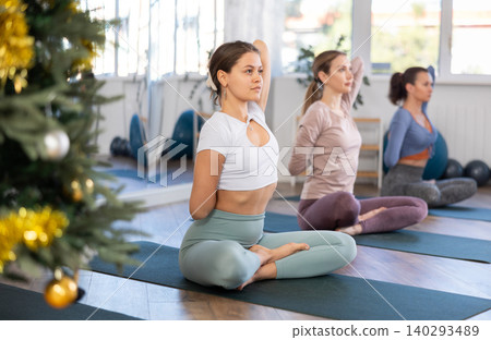 Group of women doing yoga in studio Group of women doing yoga in studio 140293489
