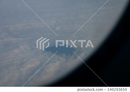 The view of the stunning landscape with mountains and clouds from the airplane window. Aerial view of the natural scene, mountain range. Travel and landscape scene. Travel and nature concept. The view of the stunning landscape with mountains and clouds from the airplane window. Aerial view of the natural scene, mountain range. Travel and landscape scene. Travel and nature concept. 140293650