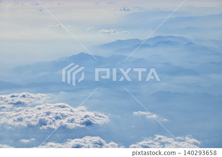 The view of the stunning landscape with mountains and clouds from the airplane window. Aerial view of the natural scene, mountain range. Travel and landscape scene. Travel and nature concept. The view of the stunning landscape with mountains and clouds from the airplane window. Aerial view of the natural scene, mountain range. Travel and landscape scene. Travel and nature concept. 140293658