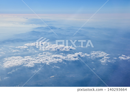 The view of the stunning landscape with mountains and clouds from the airplane window. Aerial view of the natural scene, mountain range. Travel and landscape scene. Travel and nature concept. The view of the stunning landscape with mountains and clouds from the airplane window. Aerial view of the natural scene, mountain range. Travel and landscape scene. Travel and nature concept. 140293664