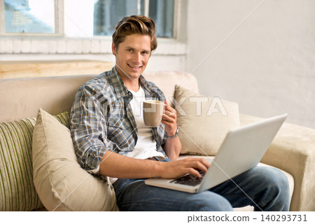 Man, portrait and laptop on sofa with coffee as freelance journalist for online research, connectivity or networking. Male person, couch and internet for remote work in London, communication or web 140293731