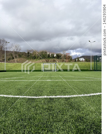 Outdoor artificial turf soccer field on a cloudy day. Sports ground for active outdoor living 140293904