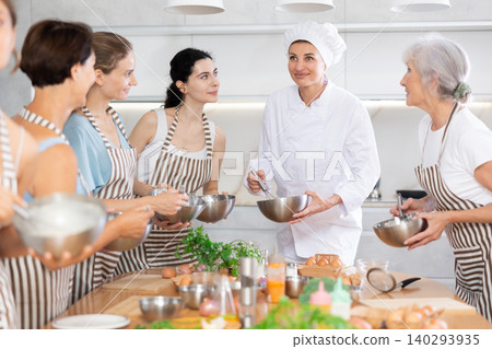 Young lady chef during open culinary lesson tells visitors stages of cooking spicy cream sauce 140293935