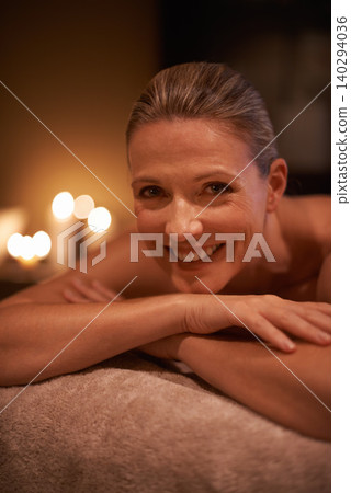 Female person, smile and spa for wellness, relax and self care and massage on table being happy. Woman, body treatment and portrait to destress, peace and detox for calm and holistic relaxation 140294036