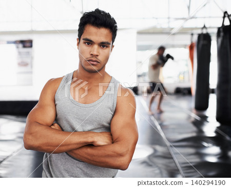 Exercise, training and portrait of man in gym for sport, practice or wellness for health. Personal trainer, face and serious expression with arms crossed for confidence, fight skill or development Exercise, training and portrait of man in gym for sport, practice or wellness for health. Personal trainer, face and serious expression with arms crossed for confidence, fight skill or development 140294190