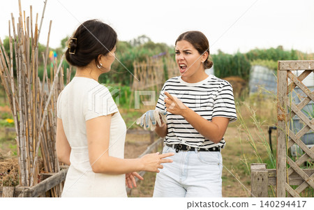 Farm owner scolding female worker during harvest 140294417