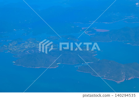 Looking from the airplane window with Hong Kong cityscape. The view of Hong Kong city, Hong Kong landscape from the above. Landscape, travel concept and nature scene.  140294535