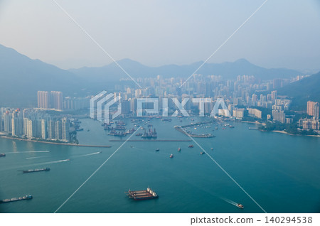 Looking from the airplane window with Hong Kong cityscape. The view of Hong Kong city, Hong Kong landscape from the above. Landscape, travel concept and nature scene. Looking from the airplane window with Hong Kong cityscape. The view of Hong Kong city, Hong Kong landscape from the above. Landscape, travel concept and nature scene. 140294538