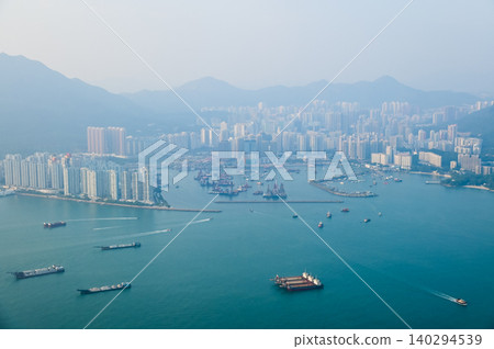 Looking from the airplane window with Hong Kong cityscape. The view of Hong Kong city, Hong Kong landscape from the above. Landscape, travel concept and nature scene. Looking from the airplane window with Hong Kong cityscape. The view of Hong Kong city, Hong Kong landscape from the above. Landscape, travel concept and nature scene. 140294539