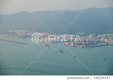 Looking from the airplane window with Hong Kong cityscape. The view of Hong Kong city, Hong Kong landscape from the above. Landscape, travel concept and nature scene. Looking from the airplane window with Hong Kong cityscape. The view of Hong Kong city, Hong Kong landscape from the above. Landscape, travel concept and nature scene. 140294547