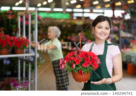 Portrait of female worker in greenhouse where flowers are grown 140294741