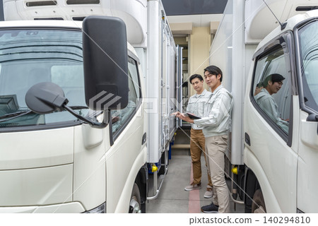 Drivers performing pre-departure inspections of delivery trucks Drivers performing pre-departure inspections of delivery trucks 140294810