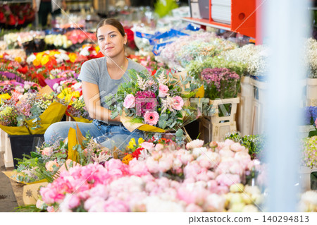 Female shopper chooses a chic bouquet of flowers at flower market Female shopper chooses a chic bouquet of flowers at flower market 140294813